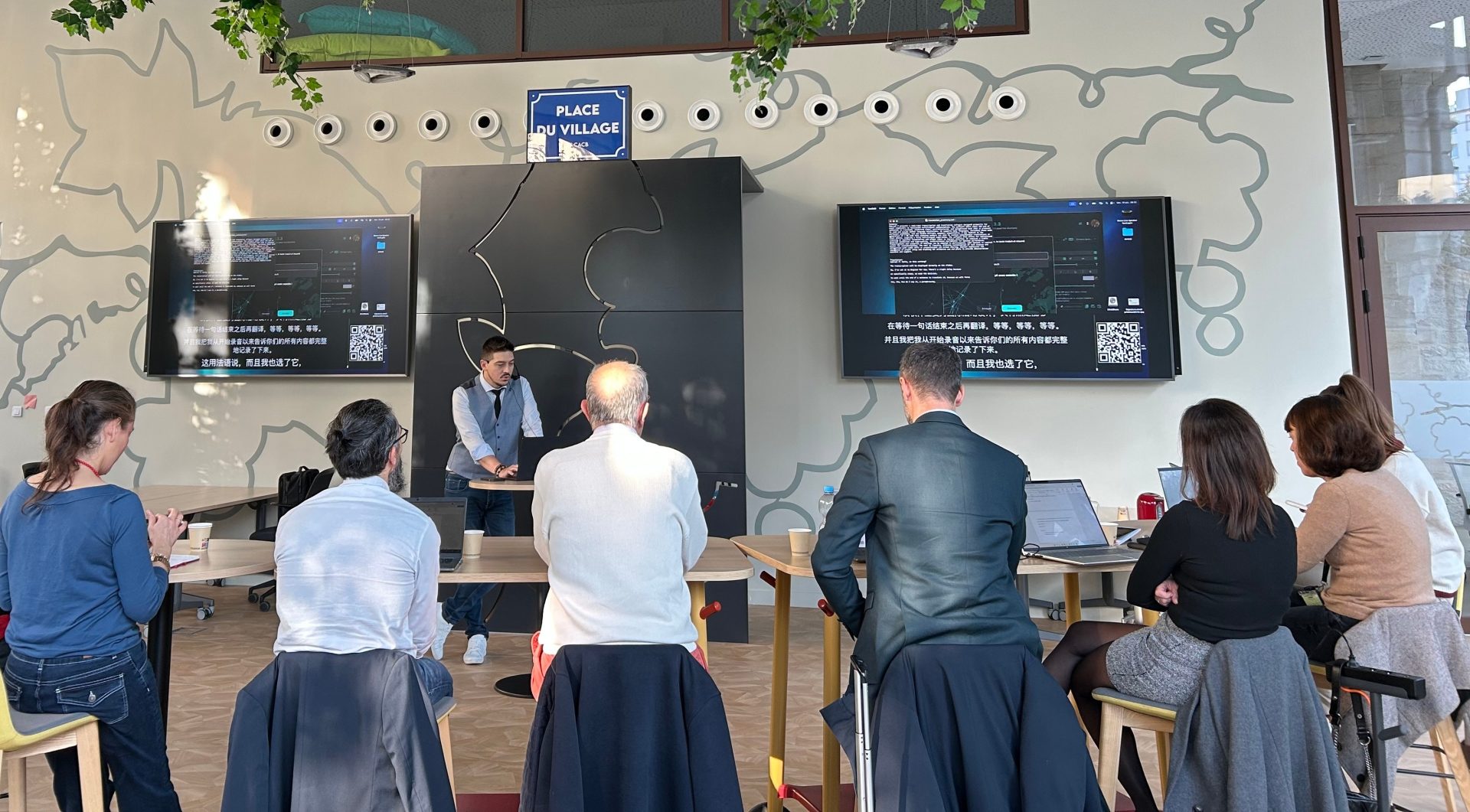 une présentation sur la place du village by ca devant les équipes